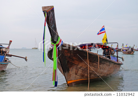 Traditional longtail boats on the Ao Nang beach at morning Traditional longtail boats on the Ao Nang beach at morning 11032942