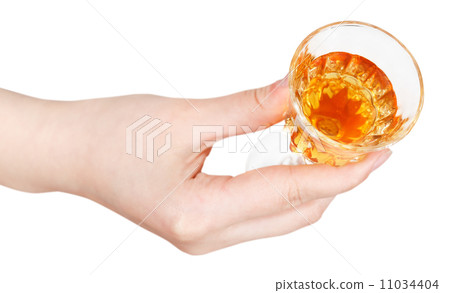 top view of hand holding glass of dessert wine 11034404