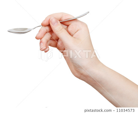 steel teaspoon in hand isolated on white 11034573