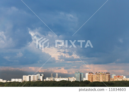 dark blue rainy clouds in sunset sky over city dark blue rainy clouds in sunset sky over city 11034603
