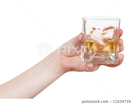hand holds glass with whiskey isolated 11034739