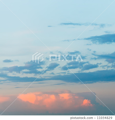 pink fluffy clouds in blue sunset sky 11034829