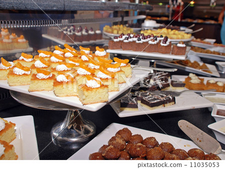 Dessert bar with assorted fruit and chocolate sweets. 11035053