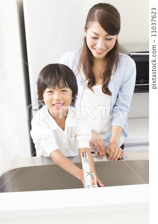 Mother and son washing hands in the kitchen Mother and son washing hands in the kitchen 11037623