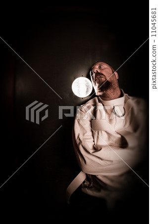 Crazy person in a cell wearing a straitjacket 11045681