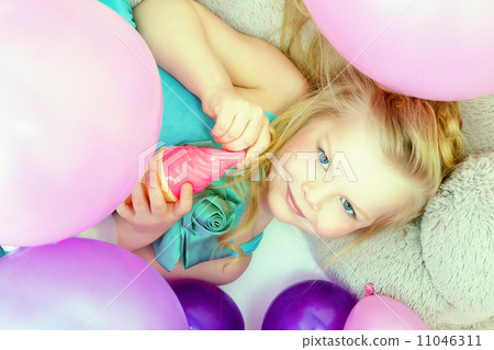 Smiling cute young girl posing at camera, close-up 11046311