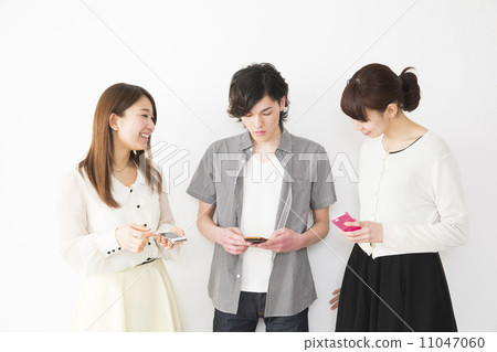 Three young people with a smartphone Three young people with a smartphone 11047060