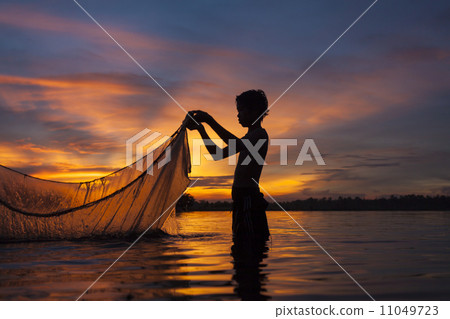 Fisherman  in action when fishing 11049723