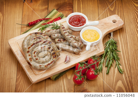 Grilled sausages with ketchup and mustard 11056048