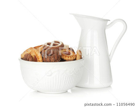 Various cookies in bowl and milk jug 11056490