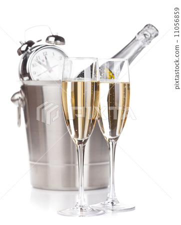 Two champagne glasses, bottle in bucket and alarm clock 11056859
