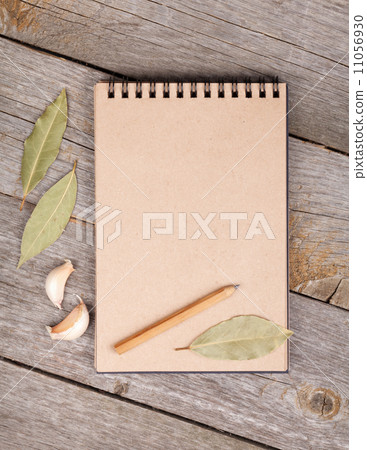 Blank notepad on wooden table 11056930