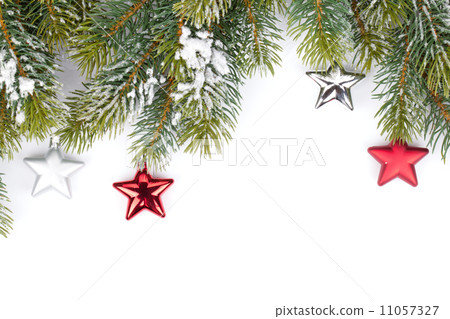 Fir tree branch with christmas decor covered with snow Fir tree branch with christmas decor covered with snow 11057327