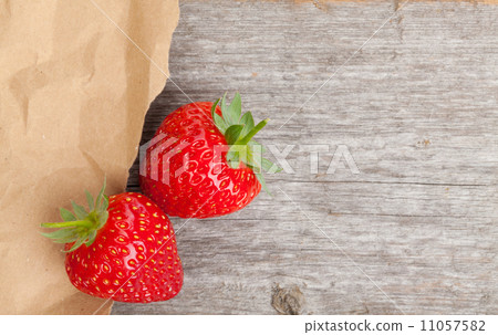 Ripe strawberries over wooden table background Ripe strawberries over wooden table background 11057582