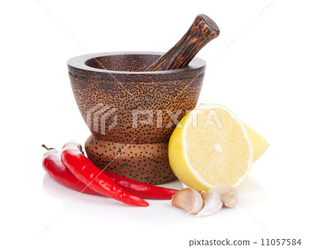 Mortar and pestle with red hot chili pepper and lemon Mortar and pestle with red hot chili pepper and lemon 11057584