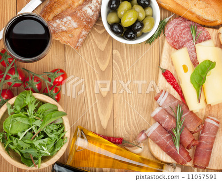 Red wine with cheese, olives, tomatoes, prosciutto, bread and sp Red wine with cheese, olives, tomatoes, prosciutto, bread and sp 11057591
