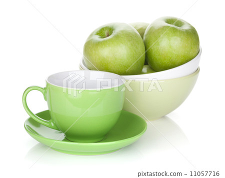 Green apples in fruit bowl and tea cup 11057716