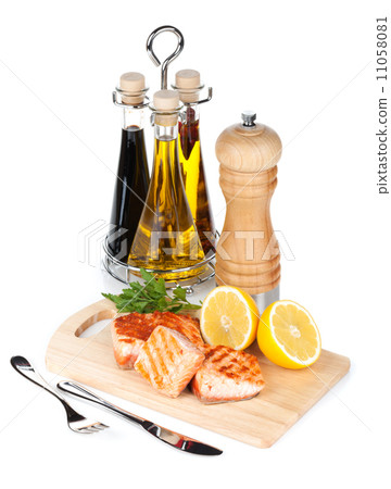 Grilled salmon with lemon and herbs on cutting board Grilled salmon with lemon and herbs on cutting board 11058081