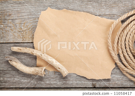 Old paper and rope on wooden textured background Old paper and rope on wooden textured background 11058417