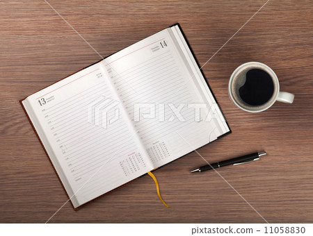 Notepad and coffee cup on wood table Notepad and coffee cup on wood table 11058830