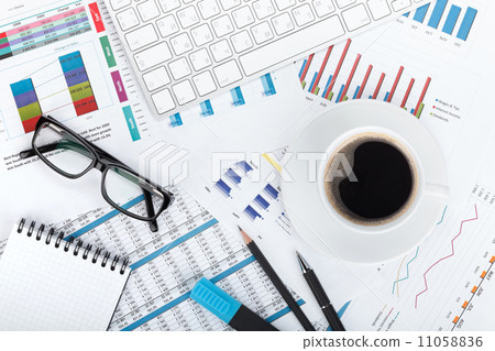 Coffee cup on financial papers Coffee cup on financial papers 11058836