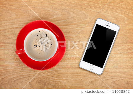 Mobile phone and coffee cup Mobile phone and coffee cup 11058842