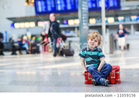Little boy going on vacations trip with suitcase at airport Little boy going on vacations trip with suitcase at airport 11059156