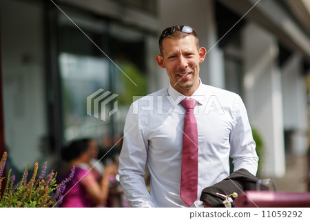 Happy caucasian groom in outdoor restaurant. 11059292