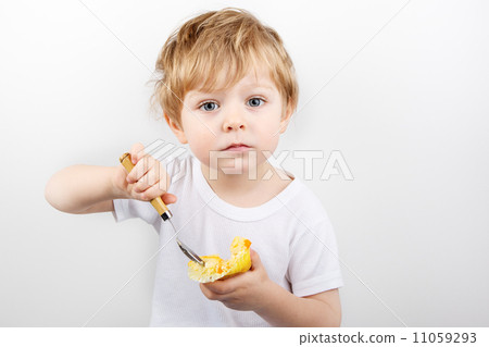 Little boy eating cheesecake muffin. Little boy eating cheesecake muffin. 11059293