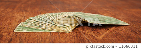 deck of playing cards expanded on fan shape on wooden table 11066311