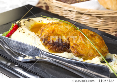 cutlets fried in carrot sauce with mashed potatoes cutlets fried in carrot sauce with mashed potatoes 11067182