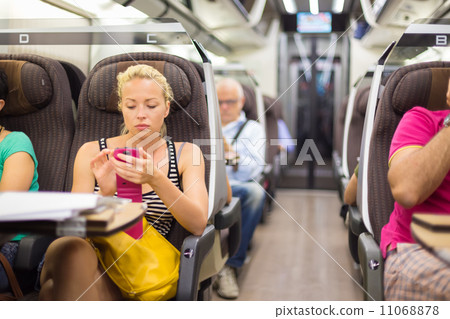 Lady traveling by train using smartphone. Lady traveling by train using smartphone. 11068878
