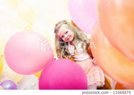 Merry curly girl posing with colorful balloons Merry curly girl posing with colorful balloons 11068879