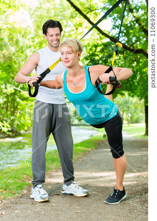 People in park on suspension or sling trainer People in park on suspension or sling trainer 11069300