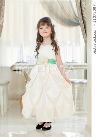 Image of smiling girl posing in long smart dress Image of smiling girl posing in long smart dress 11075097