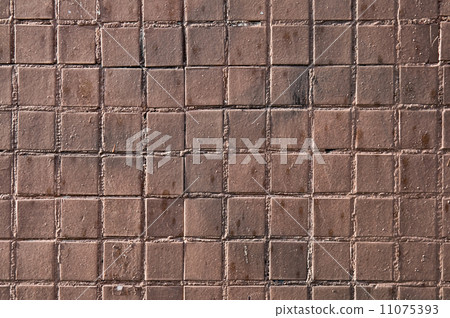 Small brown mosaic tiles on a wall 11075393
