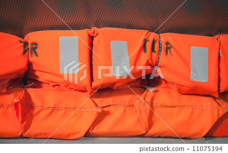 Orange life-jackets bright background Orange life-jackets bright background 11075394