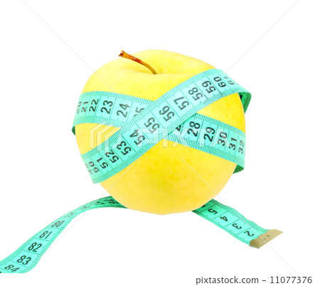 Measure tape on yellow apple Measure tape on yellow apple 11077376