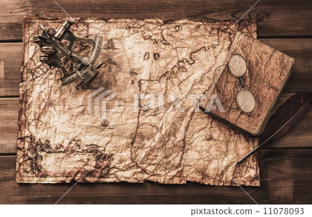 Sextant and logbook on a vintage map 11078093