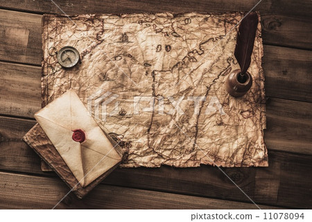 Compass, book and envelope on a vintage map 11078094
