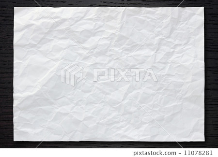 White crumpled paper on dark wood background White crumpled paper on dark wood background 11078281