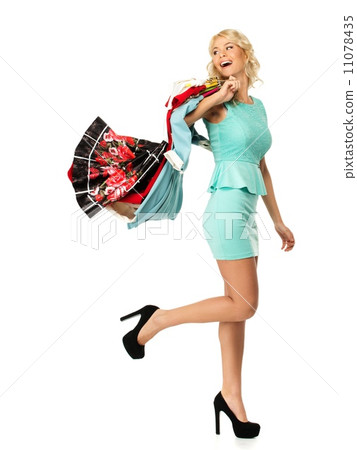 Smiling blond woman choosing clothes Smiling blond woman choosing clothes 11078435