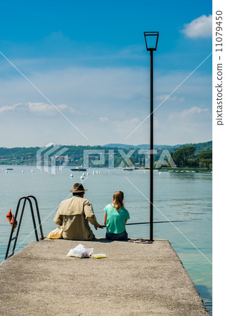 Man and girl fishing on Garda lake Man and girl fishing on Garda lake 11079450