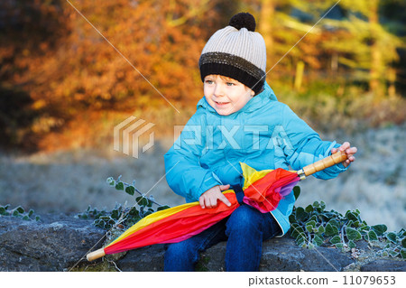Portrait of adorable toddler boy with blue jacket and colorful u Portrait of adorable toddler boy with blue jacket and colorful u 11079653