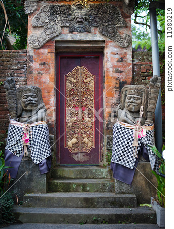 Gates of the old temple with stone guards. Indonesia, Bali. Gates of the old temple with stone guards. Indonesia, Bali. 11080219