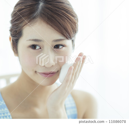 A woman with facial washing foam on her cheeks A woman with facial washing foam on her cheeks 11086078