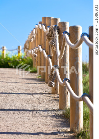 Pathway with wood post fence Pathway with wood post fence 11086933