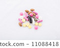 many colorful pills on a white background. symbolic photo for medicine and drugs 11088418
