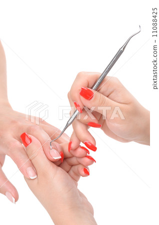 manicure applying - cleaning the cuticles  11088425