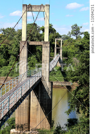 suspension bridge over river in rainforest 11094251